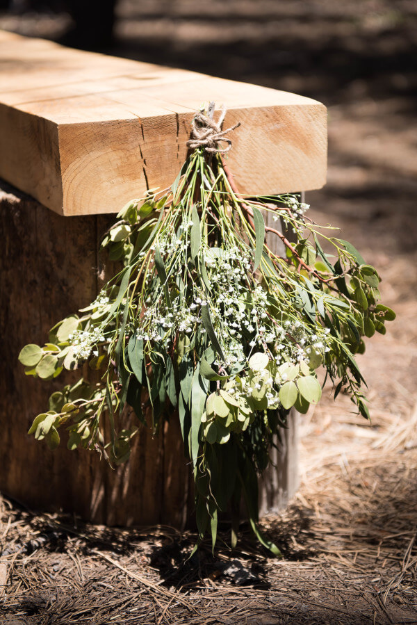 I love themed weddings. This outdoor woodland themed wedding is amazing. You must see all the sweet details! These simple swags hung on rustic benches is just one amazing detail.