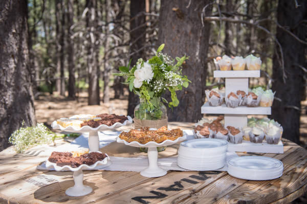 This outdoor woodland themed wedding was perfect. They displayed their desserts on an old wire spool. The rustic wood with the delicate ceramic serve ware is perfect.