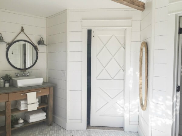 This farmhouse master bathroom makeover is incredible! Shiplap, subway tile, and raw rustic wood!!! Must see!