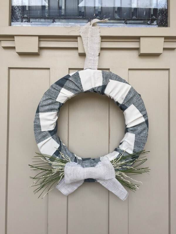 This farmhouse style buffalo check holiday wreath is the prefect addition to your decor this Christmas!
