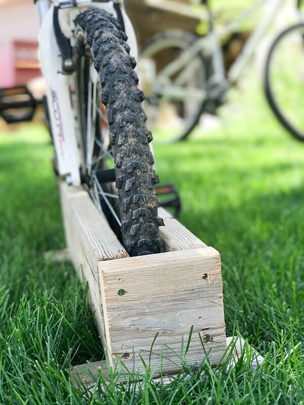 Get your kids bikes off the grass with this easy DIY bike rack! So easy to make, I made it in 10 minutes!