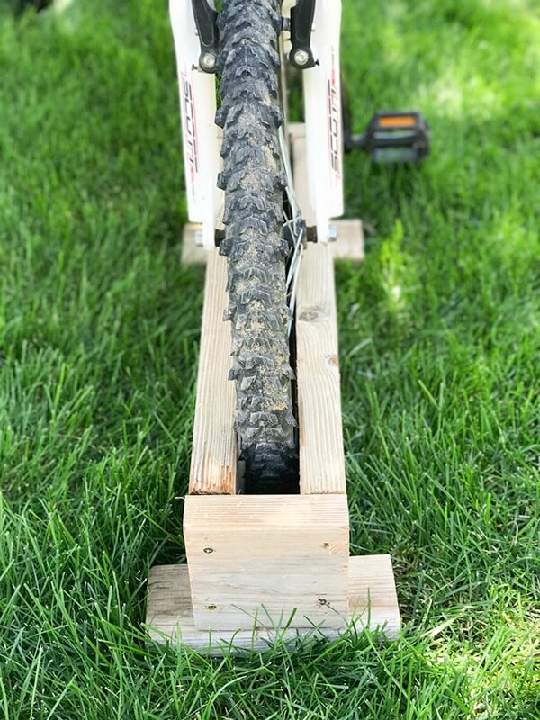 Get your kids bikes off the grass with this easy DIY bike rack! So easy to make, I made it in 10 minutes!