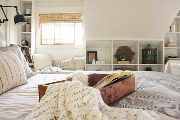Some of my favorite farmhouse bedroom features include a cozy fireplace, a comforting window seat, faux beams, farmhouse style lighting, and so much more!