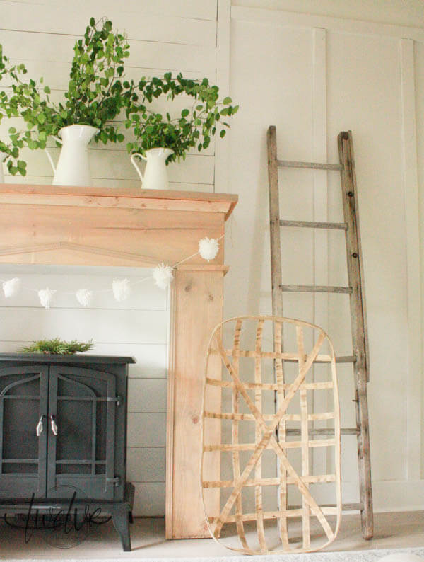 Add warmth, character and style to your home with this easy DIY faux farmhouse style fireplace and mantel. Raw wood, shiplap, and a freestanding fireplace!