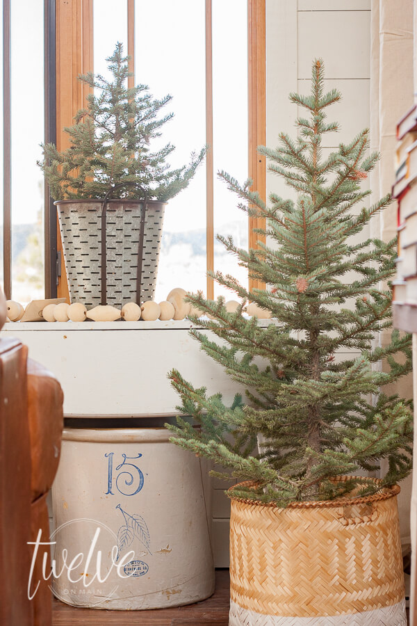 Mini Christmas trees and vintage crocks are the perfect farmhouse Christmas living room decor.