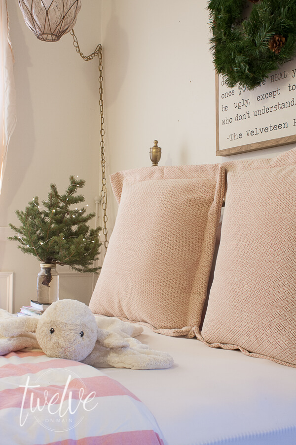 Girls bedroom decorate for Christmas with pink and green decor. A small Christmas tree and a simple holiday wreath is all you need!