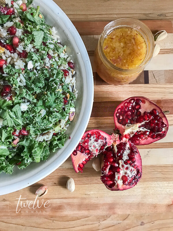 Kale, wild rice, feta cheese, and pistachios are the perfect accompaniment to this pomegranate salad~