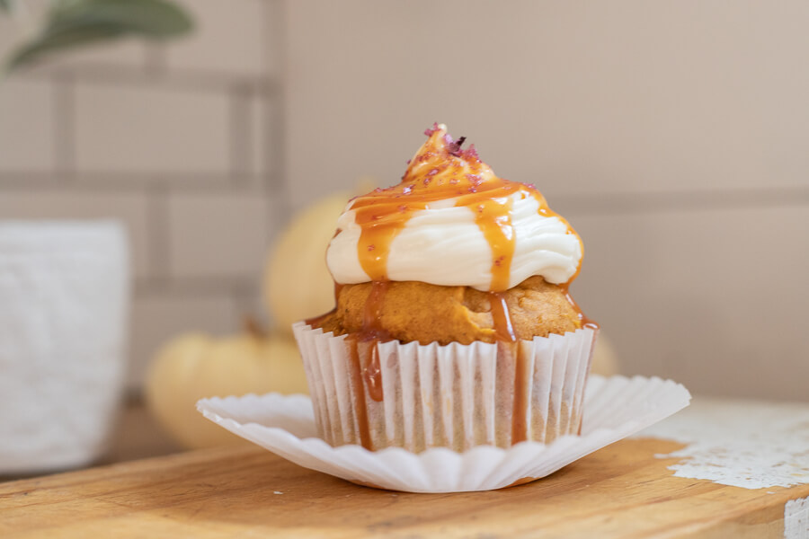 Utterly decadent fall inspired pumpkin cupcakes topped with cream cheese frosting, caramel and sea salt. It has all the flavors of fall! 