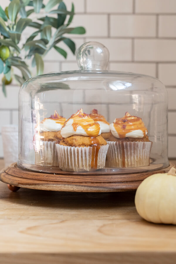 The easiest pumpkin cupcake recipe with cream cheese icing, caramel sauce drizzle and topped with a pinch of sea salt! This cupcake is perfect for fall!