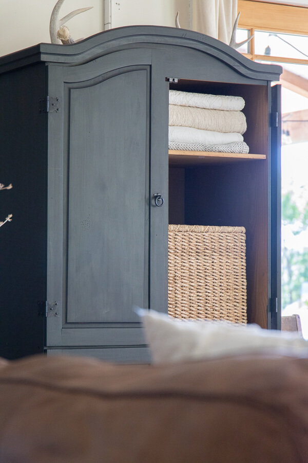 Black armoire in the living room. Stylish and functional, creating storage that is sorely needed. 