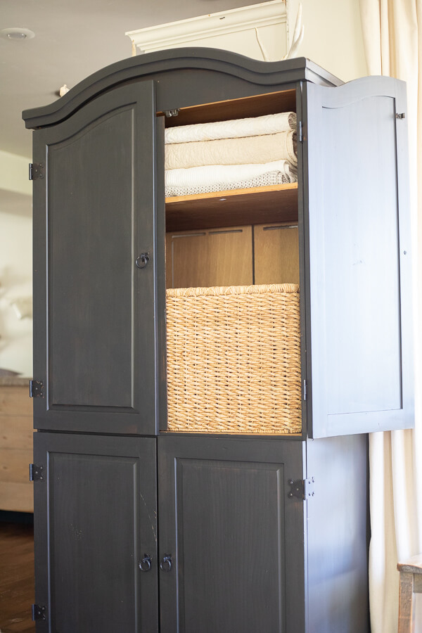 Black armoire in the living room. Stylish and functional, creating storage that is sorely needed. 