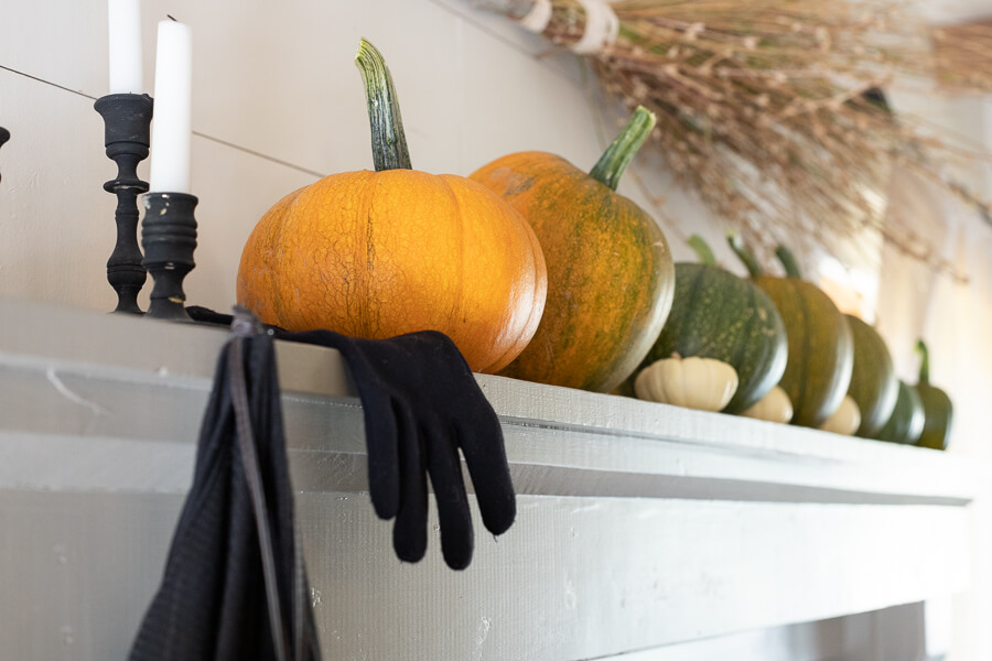 A witches broom, some baby pumpkins, and so much more in this very witchy Halloween mantel!