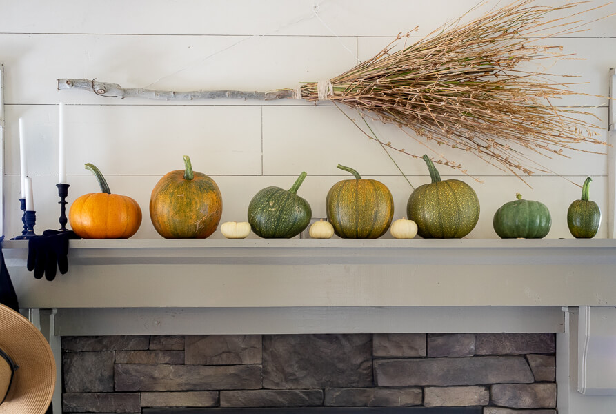 A witches broom, some baby pumpkins, and so much more in this very witchy Halloween mantel!