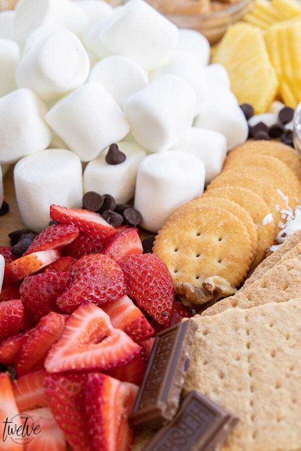 How to create a super simple and fun s'mores board that's perfect for a night our with family. I love to add marshmallows, fruits, crackers and cookies as well as peanut butter, Nutella and more!