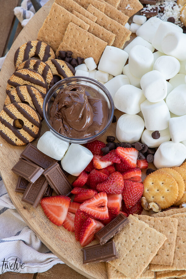 How to create a super simple and fun s'mores bar that's perfect for a night our with family.  I love to add marshmallows, fruits, crackers and cookies as well as peanut butter, Nutella and more!