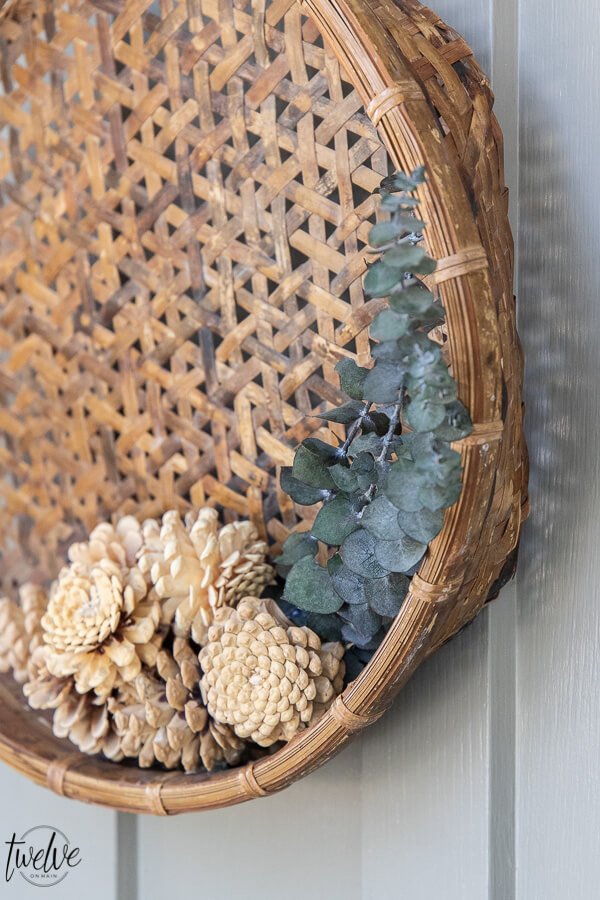 How to make a fall wreath with simple earthy elements such as eucalyptus, pine cones and baskets.