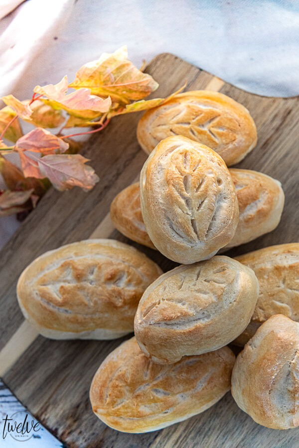 Up your fall game by serving these gorgeous fall inspired dinner rolls with a leaf cut design! This only takes about 5 minutes and you can use frozen pre-made dough or your own favorite dinner roll recipe to make them! You only need one special tool to do it!