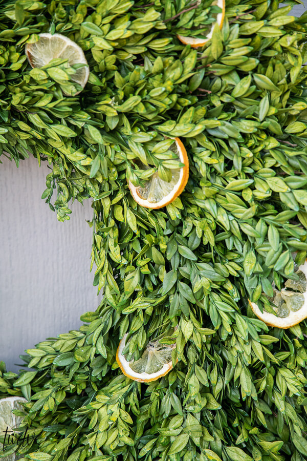 How to make a stylish boxwood and lemon summer wreath perfect for a front door or entry way.  It is easy to create and inexpensive!