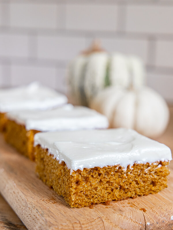 How to make this easy pumpkin sheet cake in under 1 hour! It tastes amazing, it perfect for a big crowd and is the perfect treat for fall.