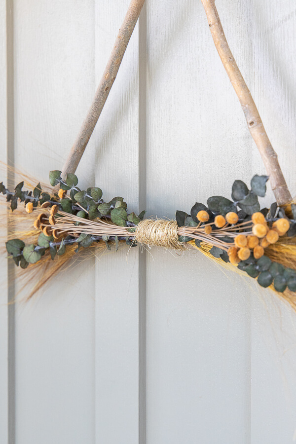 Make this easy and inexpensive nature inspired twig wreath perfect for fall! I have a step by step video tutorial as well!