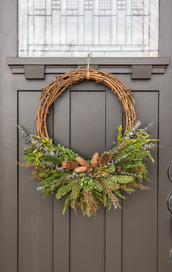 How to make a gorgeous winter door wreath perfect to use all season, well into the spring. This is a full tutorial with video on how to make one!