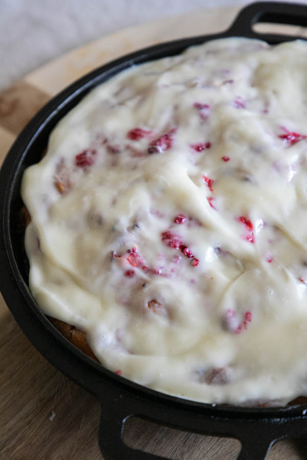 This is the perfectly sweet take on sourdough focaccia bread. This raspberry sourdough focaccia bread is sweet and tangy with juicy raspberries throughout and a decadent cream cheese icing drizzled on top.