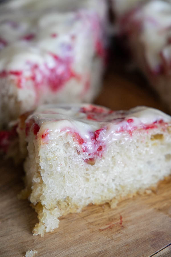 This is the perfectly sweet take on sourdough focaccia bread. This raspberry sourdough focaccia bread is sweet and tangy with juicy raspberries throughout and a decadent cream cheese icing drizzled on top.