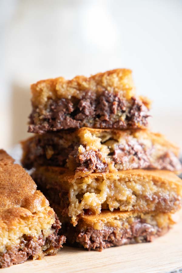 Make these amazing sourdough chocolate chip cookie bars and bring the best treat to your next party! These are super easy to make, no mixer needed. They are decadent, ooey and gooey. Bake them in your cast iron skillet for an even better crispy crust. These are such a popular treat at our house!